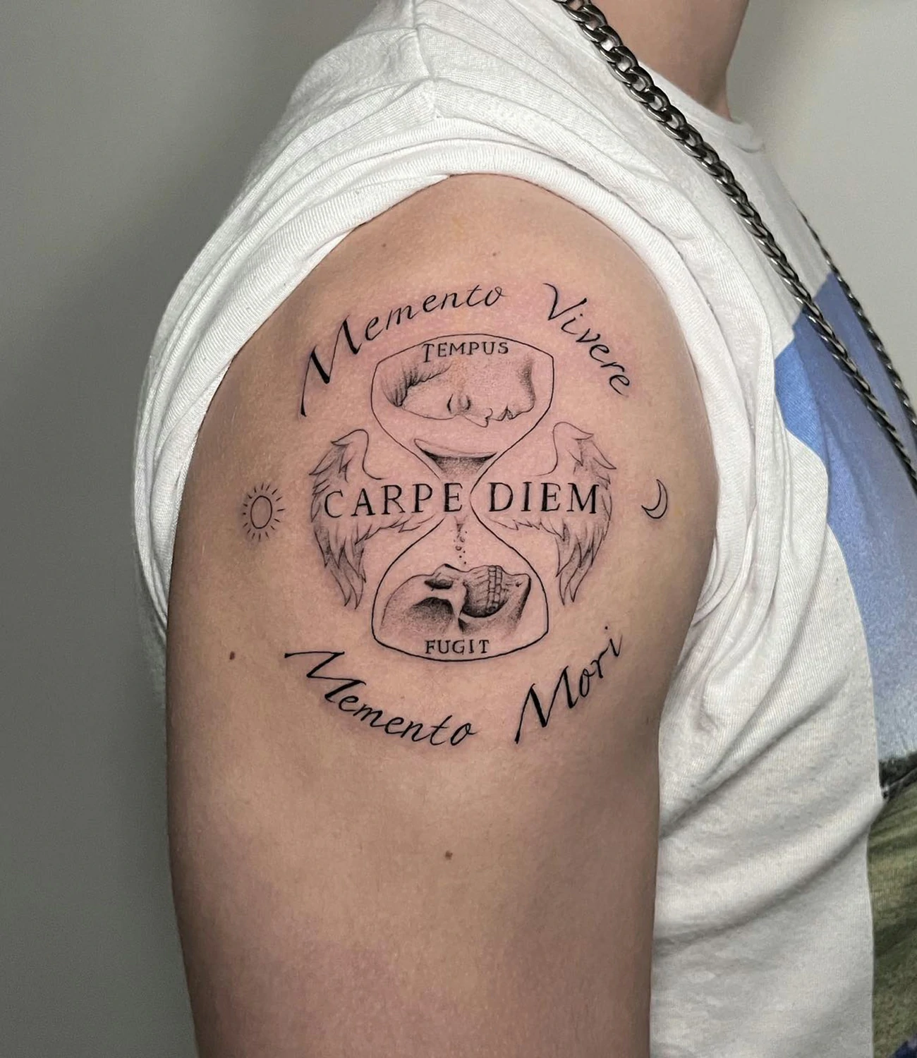 carpe diem memento mori tattoo: A tattoo that juxtaposes "memento mori" with "carpe diem," using imagery that contrasts the concepts of seizing the day and remembering mortality.