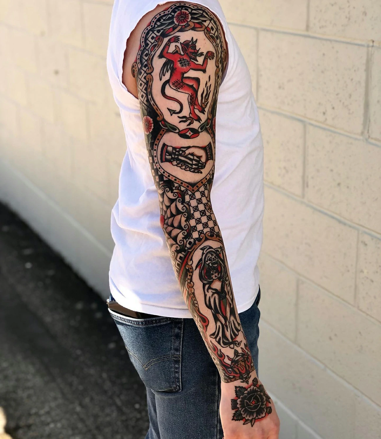memento mori sleeve tattoo: A full-sleeve tattoo incorporating "memento mori" along with various symbolic elements, creating a cohesive and intricate design.