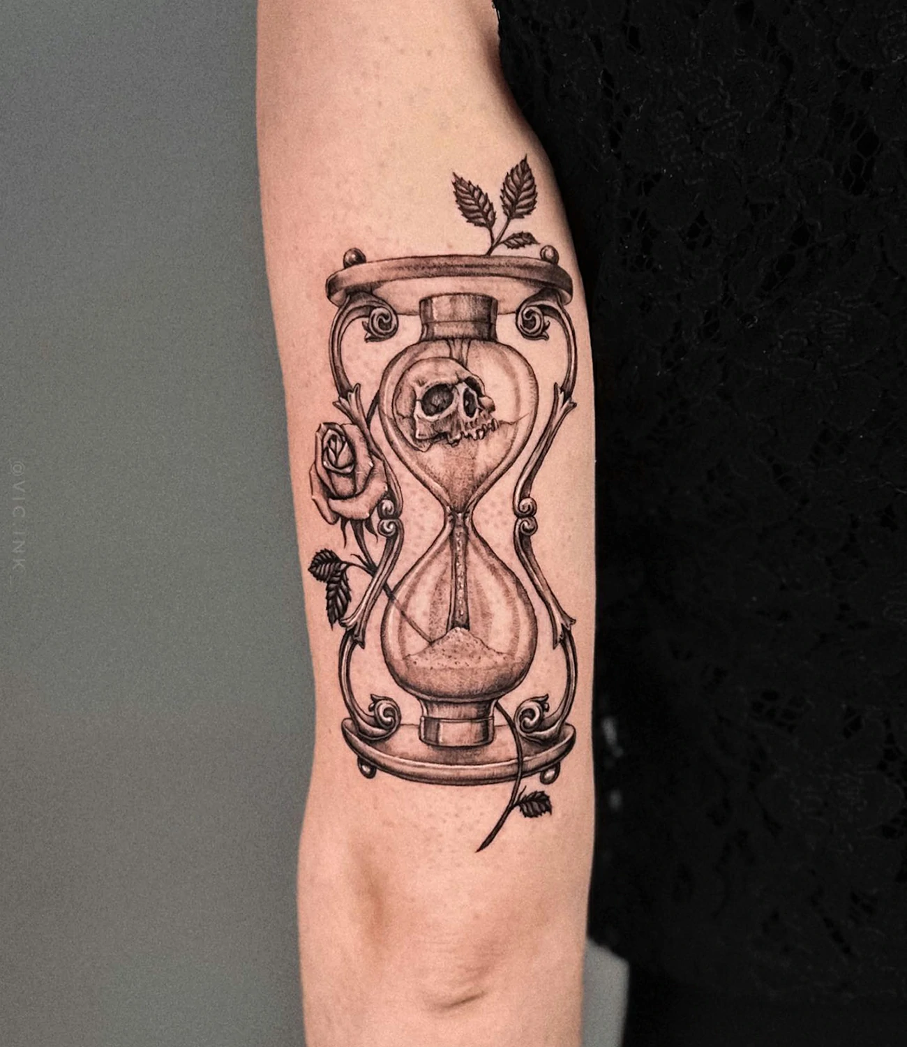 memento mori hourglass tattoo: An hourglass tattoo with the phrase "memento mori," indicating the passage of time and the inevitability of death.