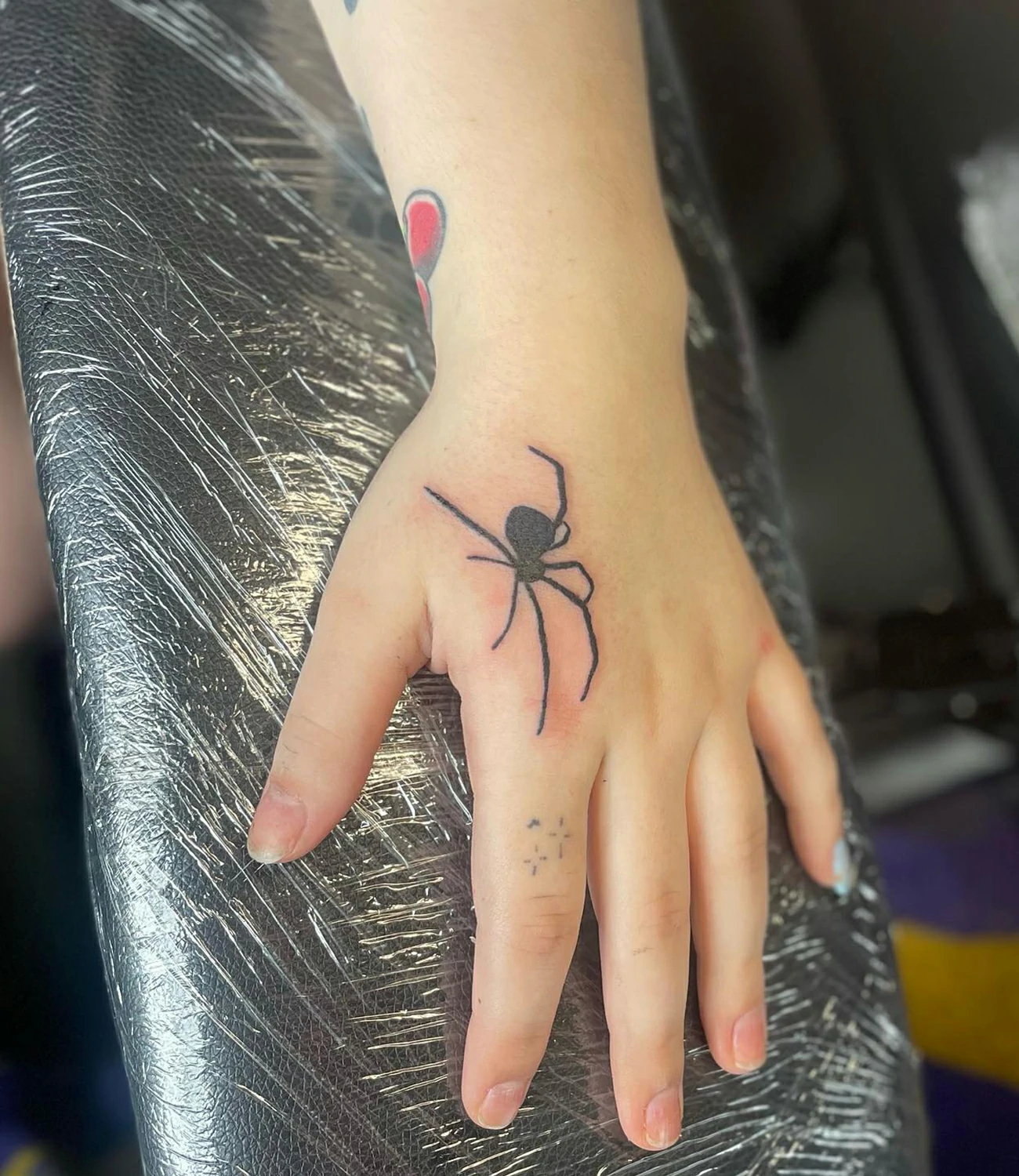 Spider tattoo on hand