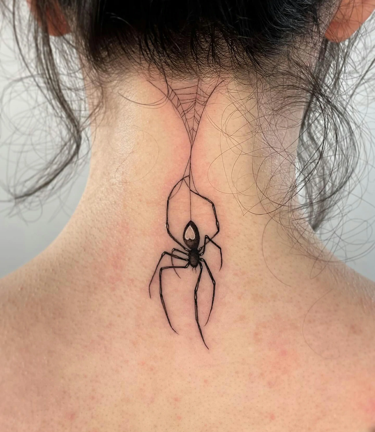 Pider tattoo on the neck