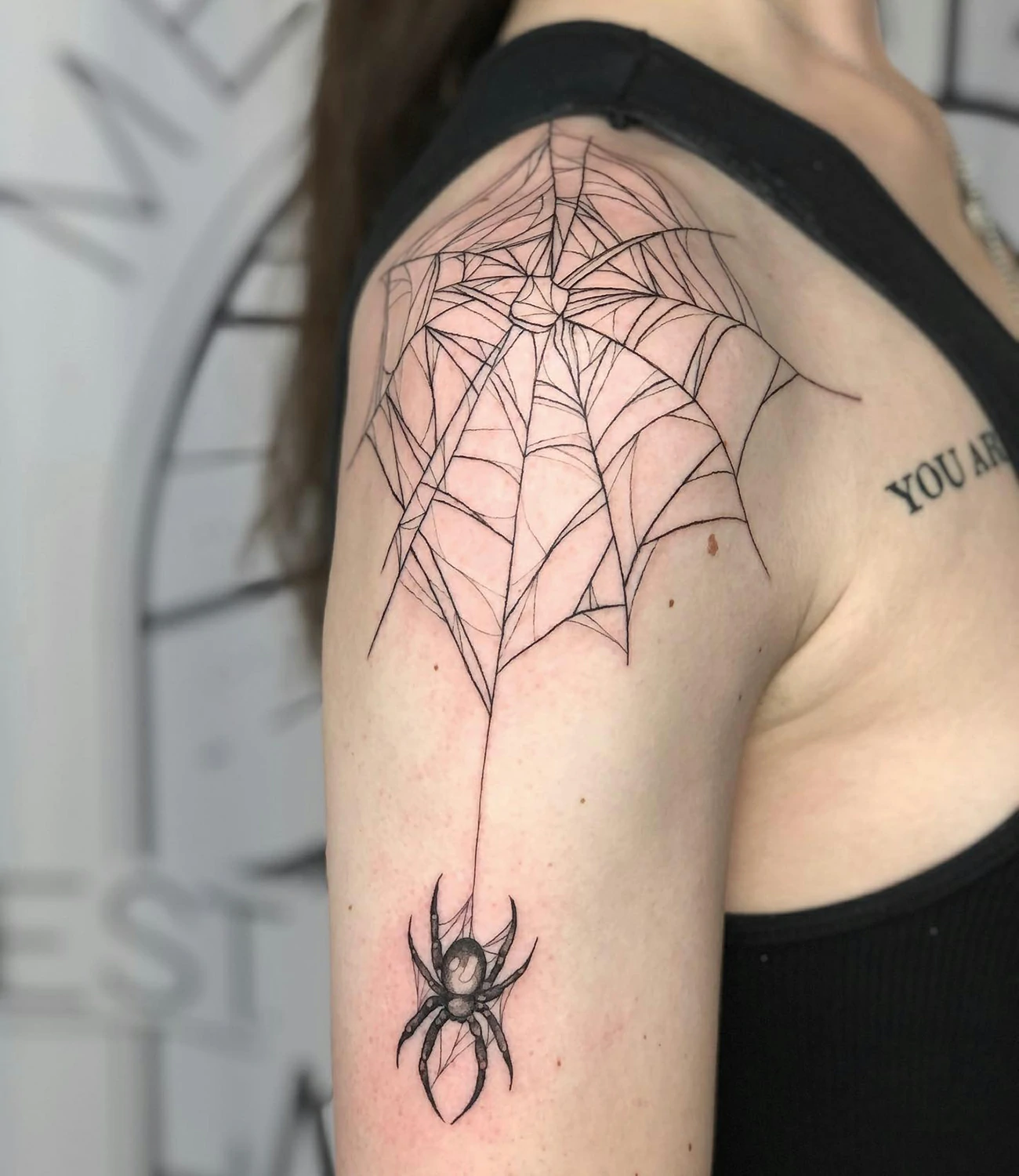 Spider web tattoo on shoulder
