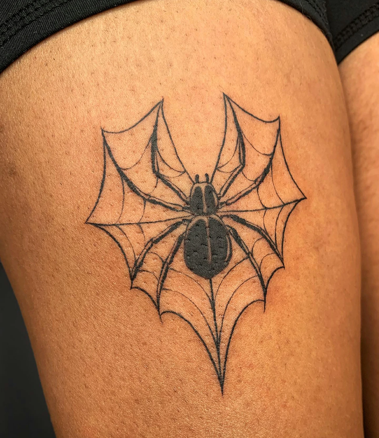 Heart spider web tattoo