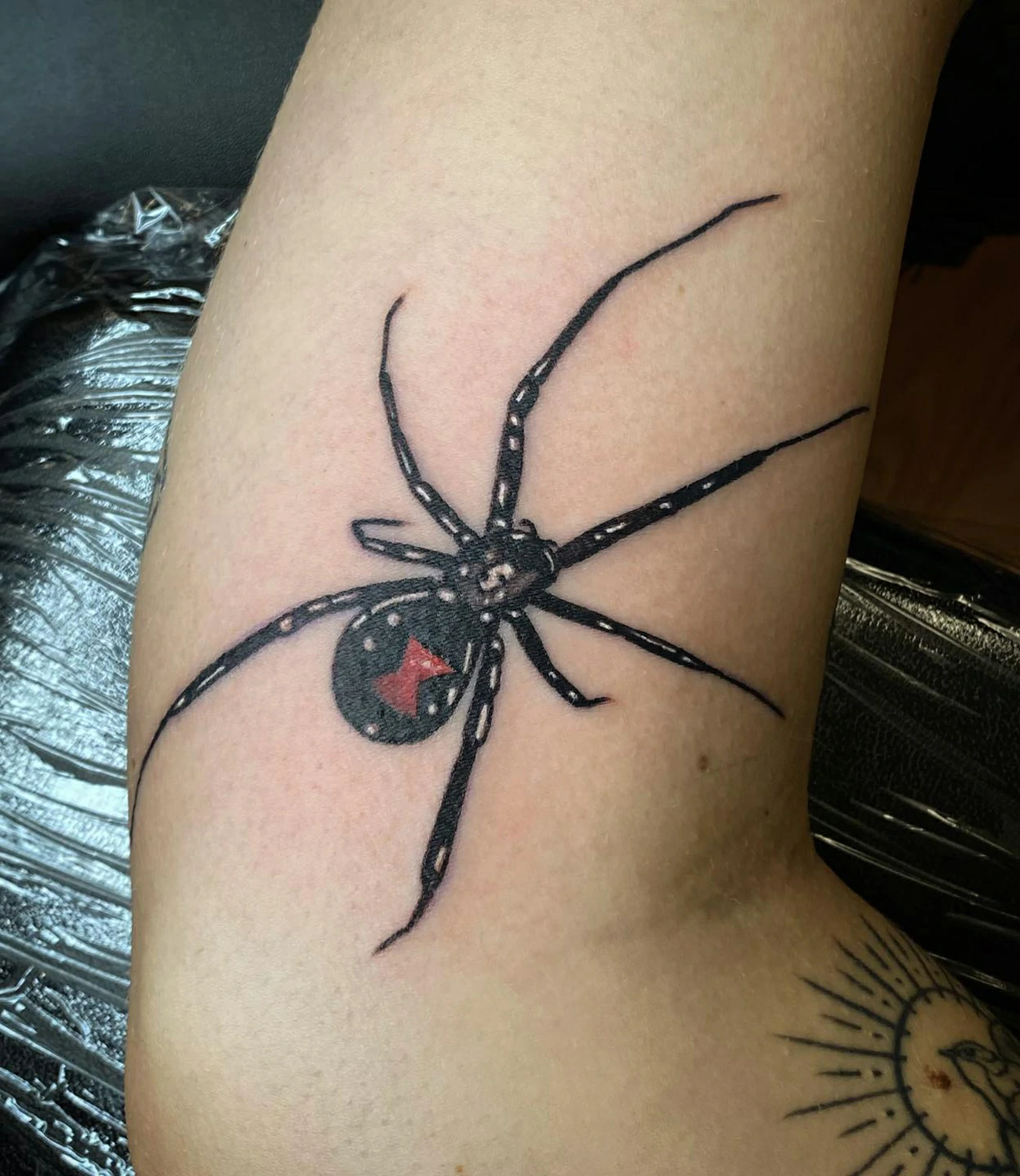 Black widow spider tattoo