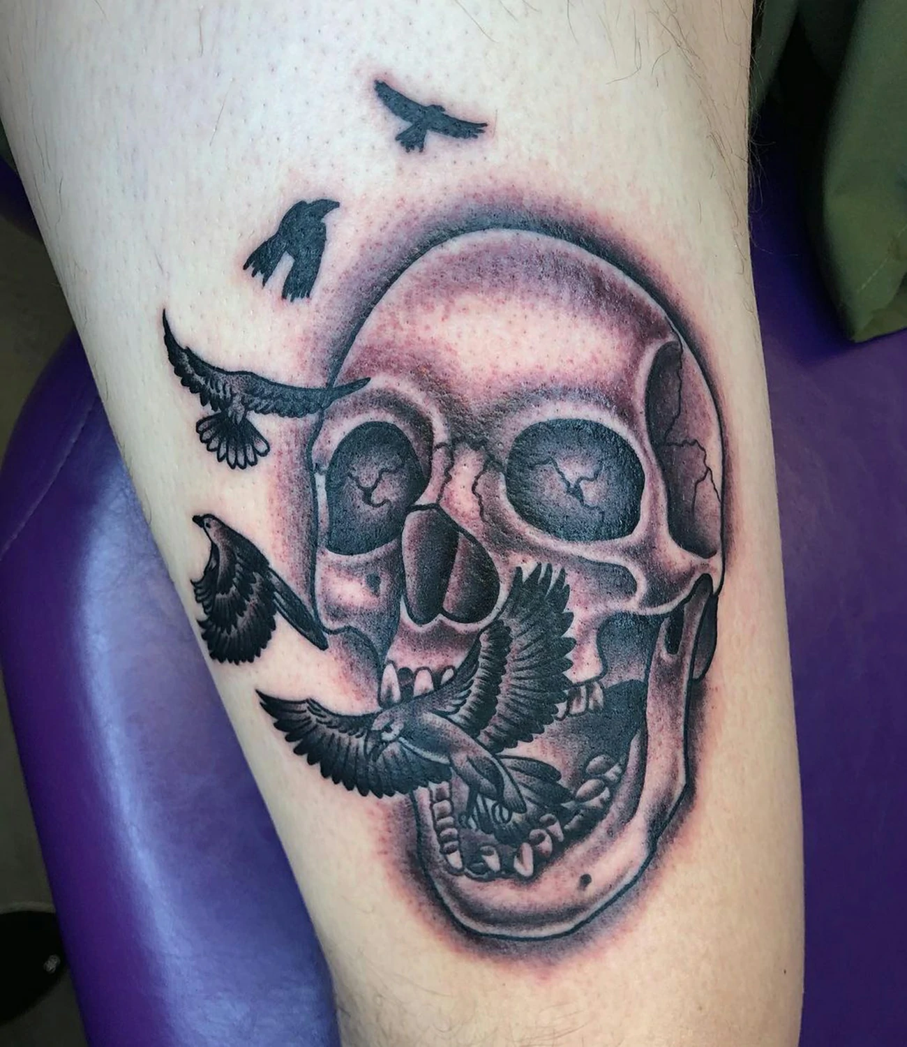 Raven and skull tattoo: An artistic tattoo that features both a raven and a skull.
