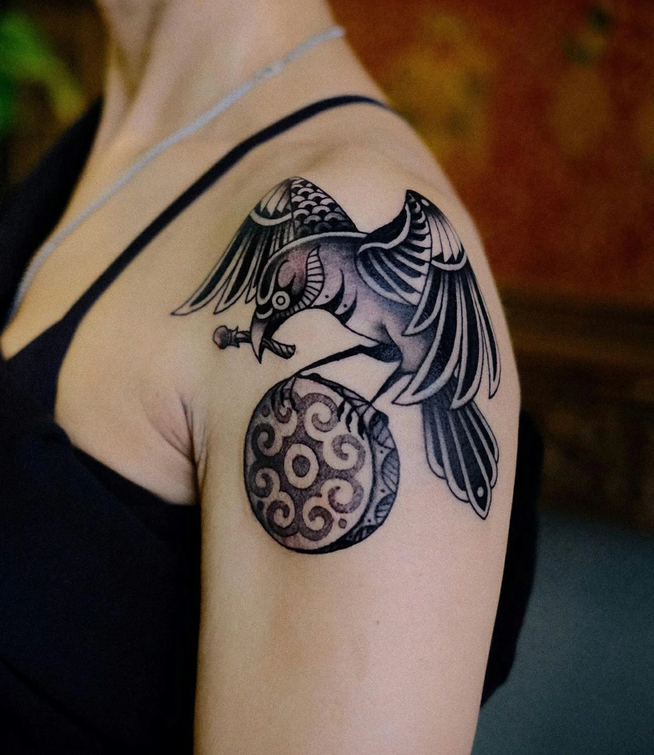 Traditional raven tattoo: Classic raven tattoo using traditional tattoo techniques.