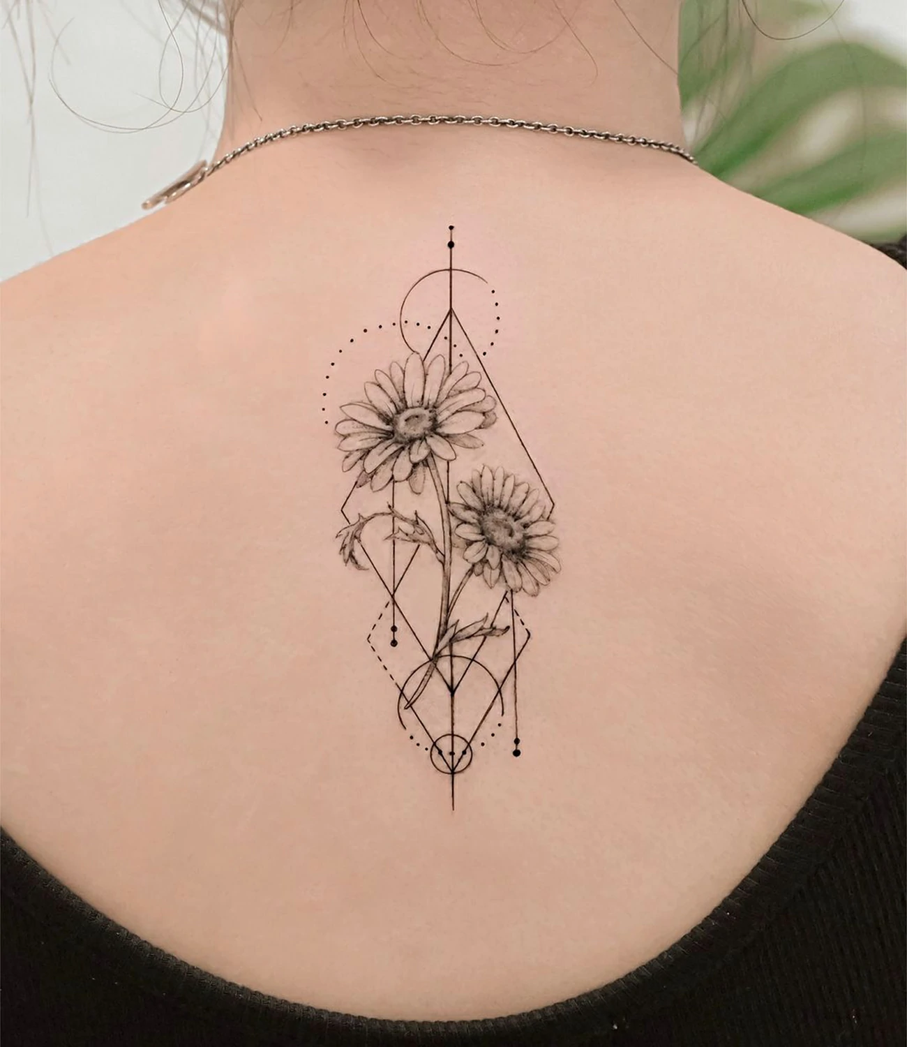 Geometric Floral Tattoo: Geometric floral tattoos merge the elegance of flowers with the precision of geometric shapes, symbolizing beauty and the harmony of nature.