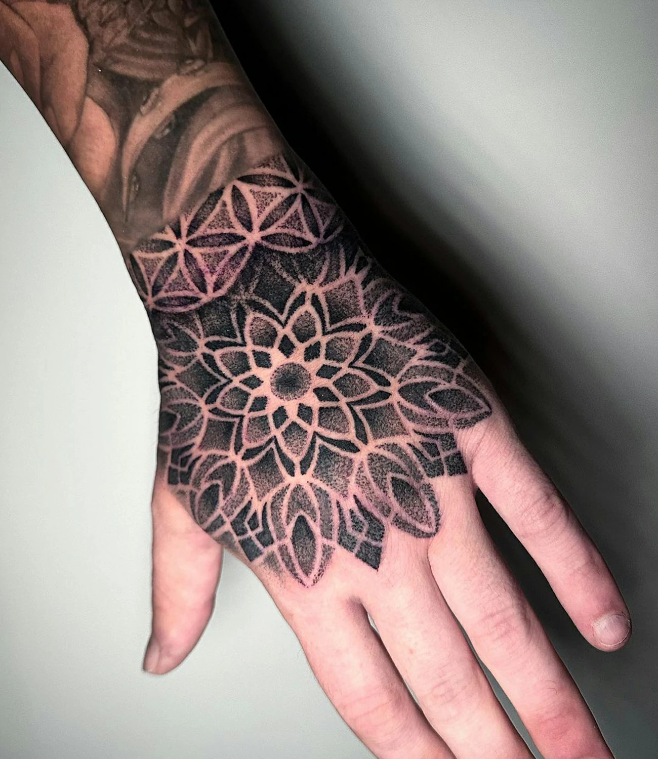 Geometric Hand Tattoo: Geometric hand tattoos feature symmetrical shapes and patterns that complement the natural lines of the hand, making a bold statement.