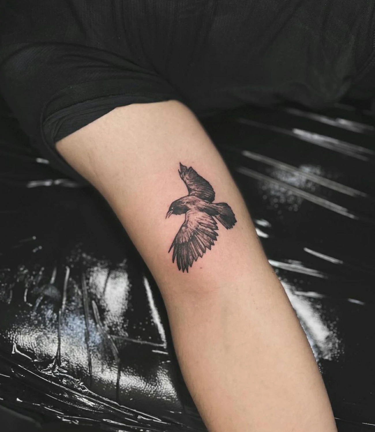 Small raven tattoo: A compact and subtle raven design for a minimalist look.