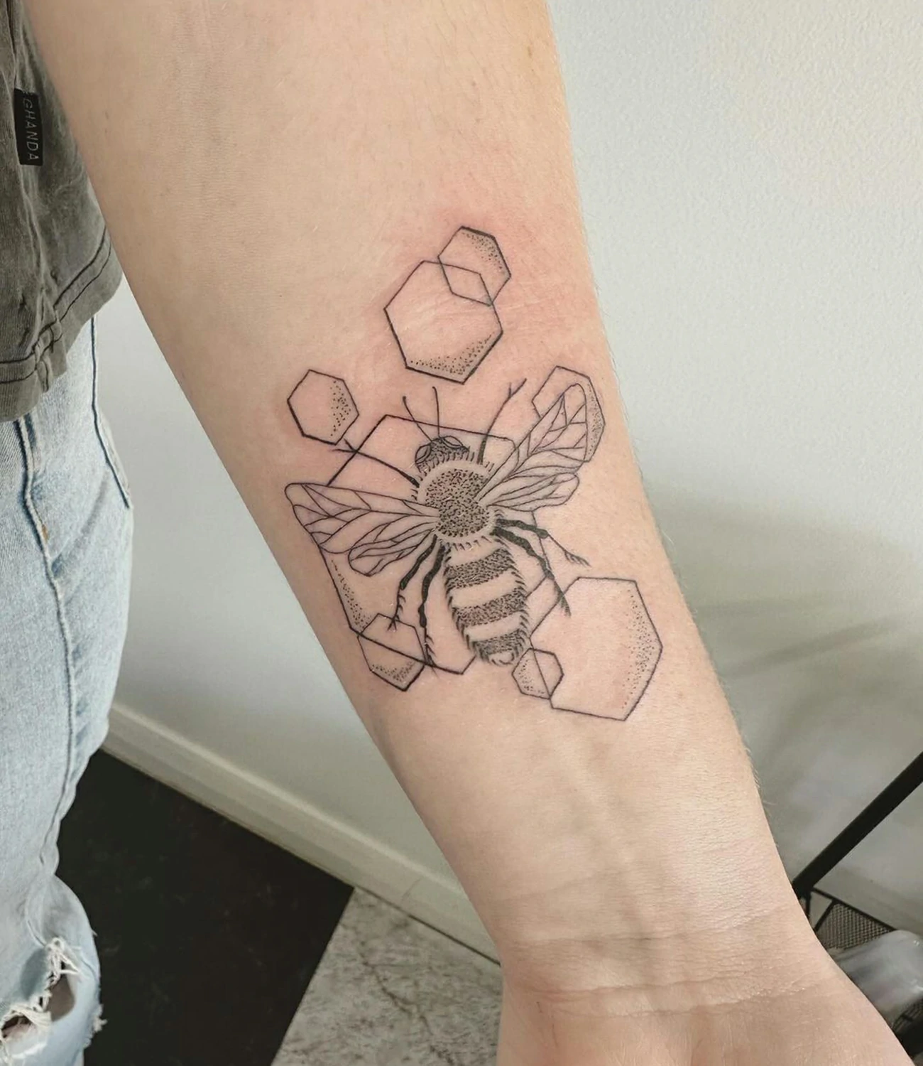 Geometric Bee Tattoo: Geometric bee tattoos blend the industrious image of a bee with geometric shapes, symbolizing hard work and community.