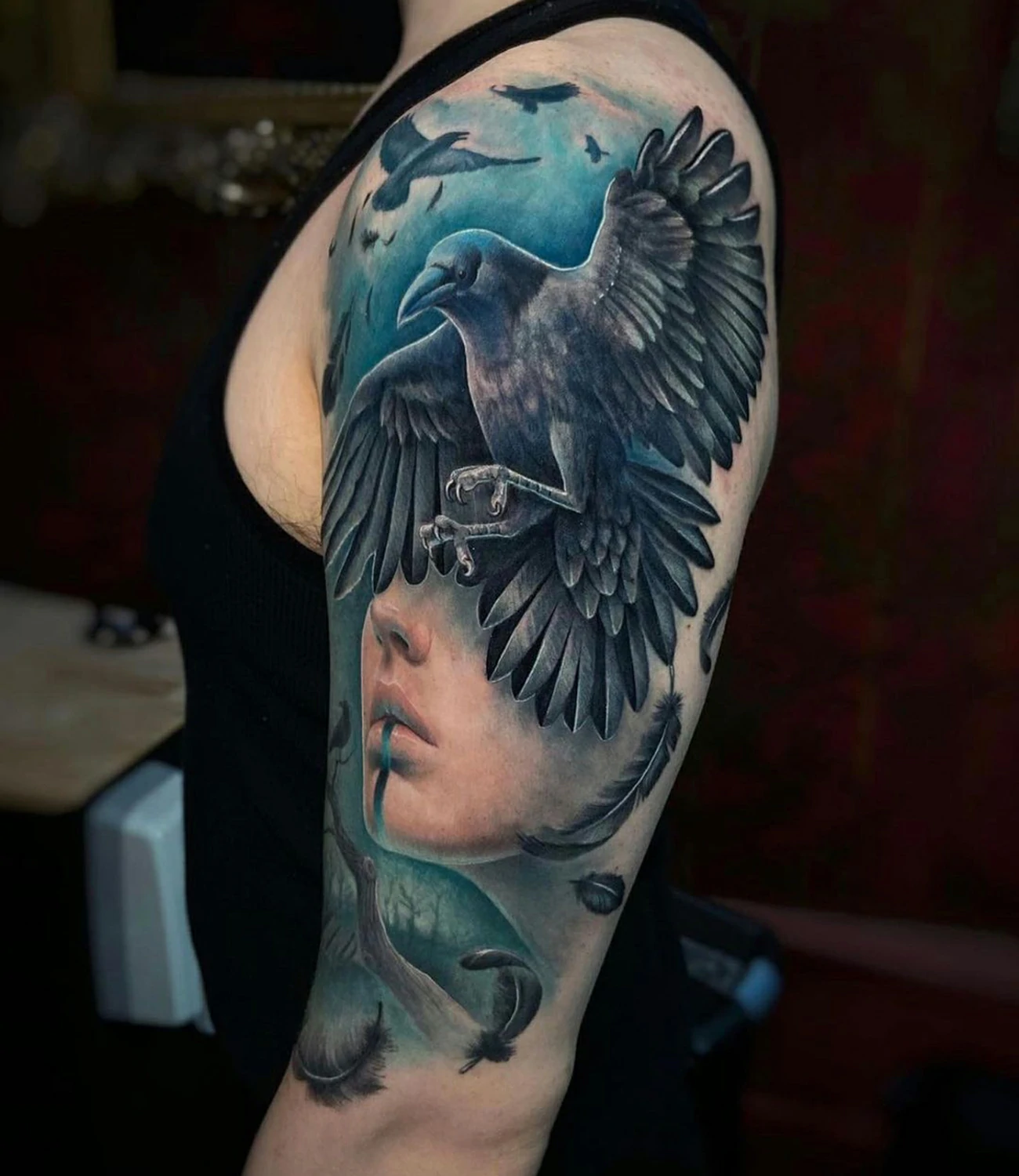 Raven shoulder tattoo: A raven tattoo designed to wrap around the shoulder.