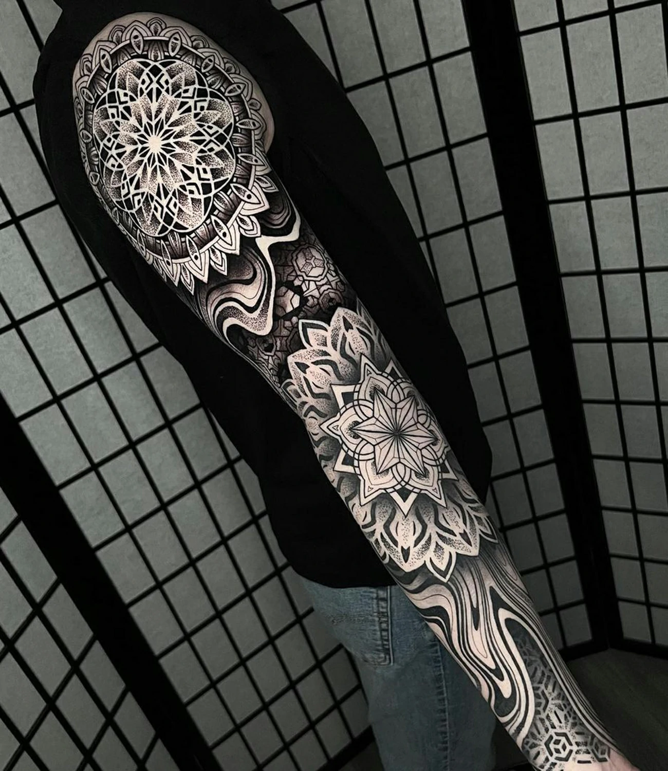 Geometric Tattoo Sleeve: A geometric tattoo sleeve covers the arm with interconnected shapes and patterns, offering a cohesive and visually stunning artwork.