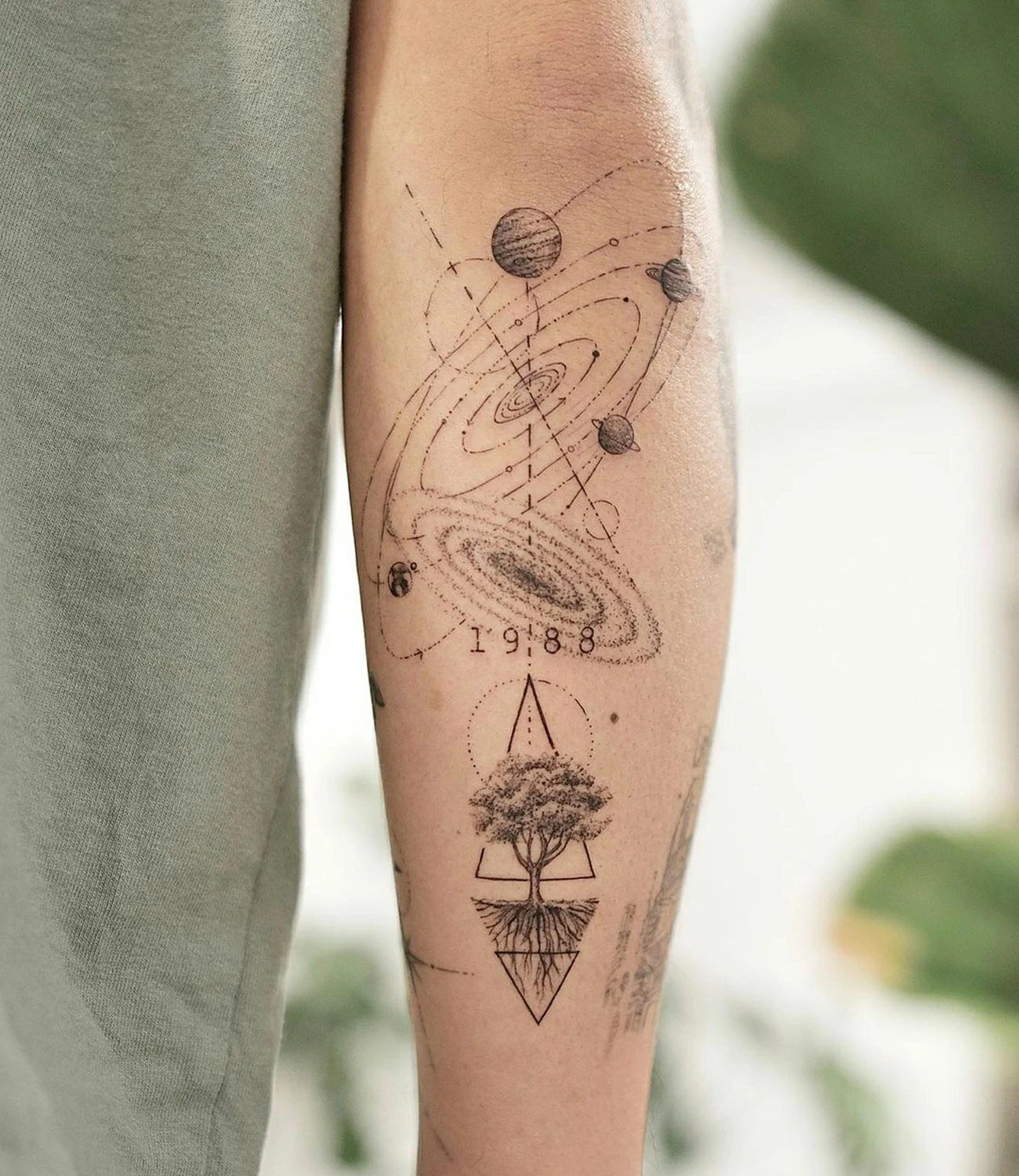 Geometric Space Tattoos
Geometric space tattoos combine celestial themes like stars, planets, and galaxies with intricate geometric patterns, creating designs that symbolize the infinite and mysterious nature of the universe.