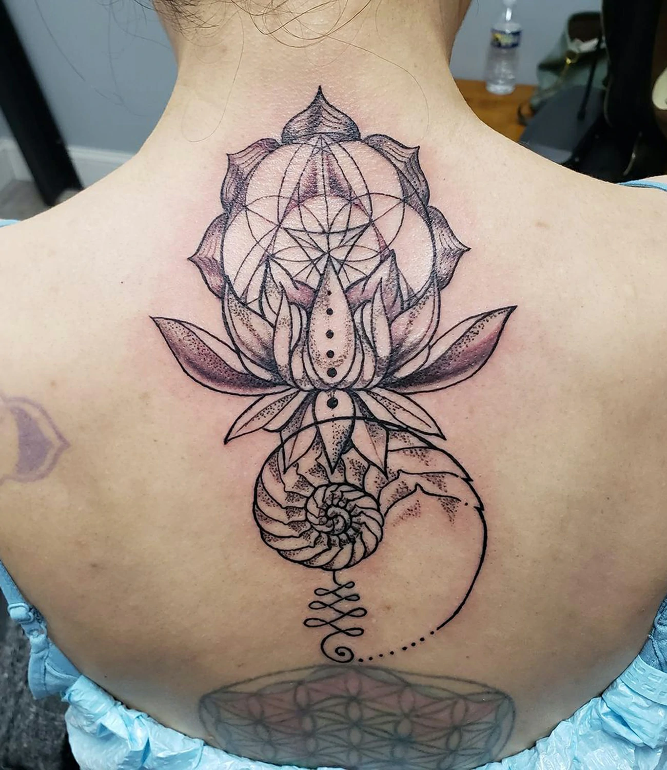 geometric lotus flower tattoo