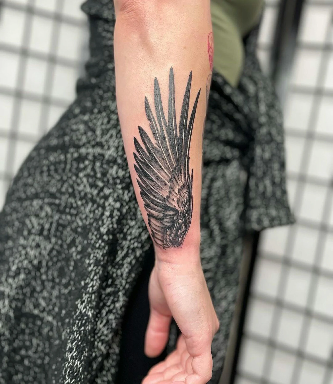 Raven wing tattoo: A tattoo emphasizing the detail and spread of a raven’s wings.