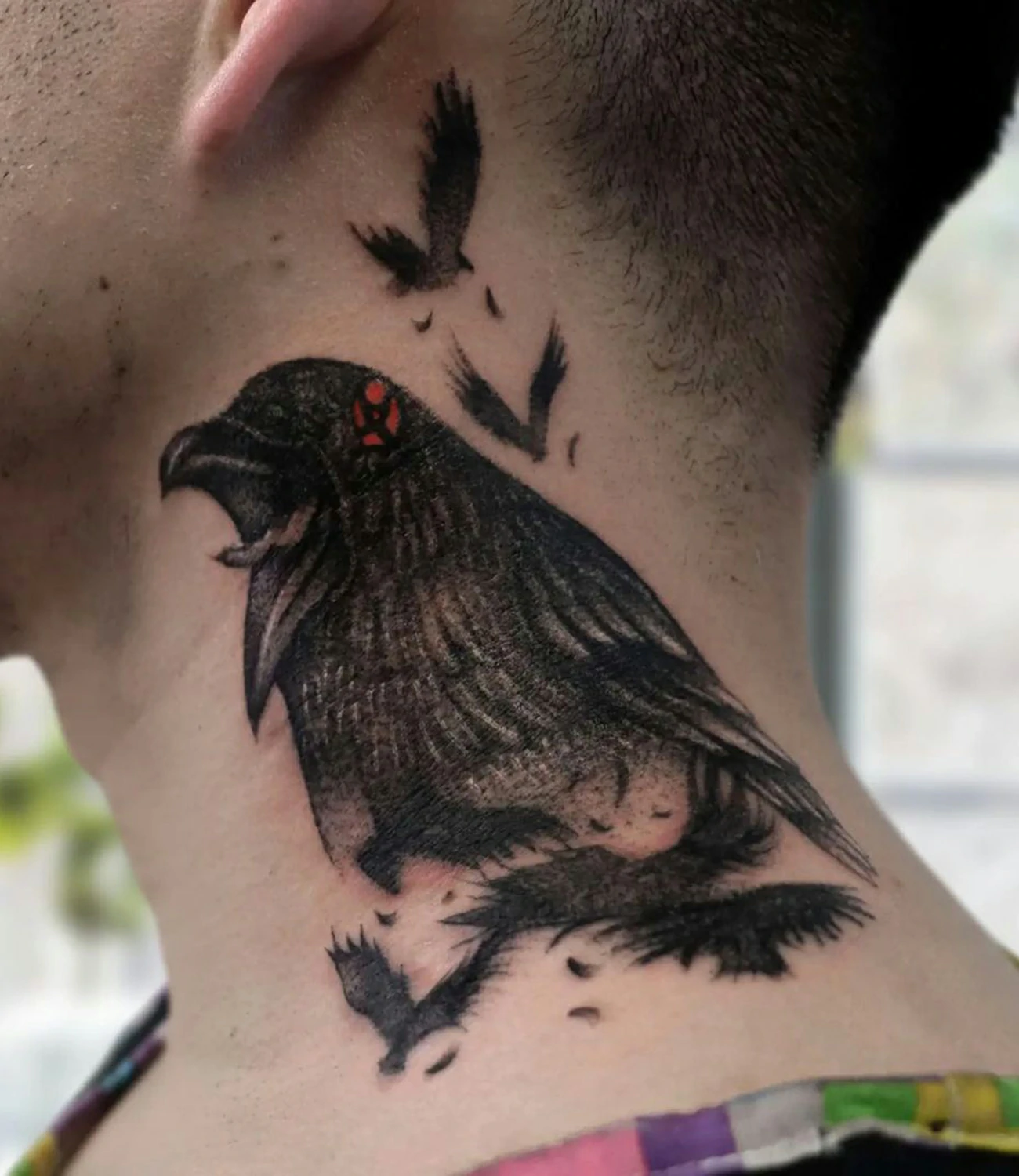 Raven neck tattoos: Tattoos designed specifically to be placed on the neck.