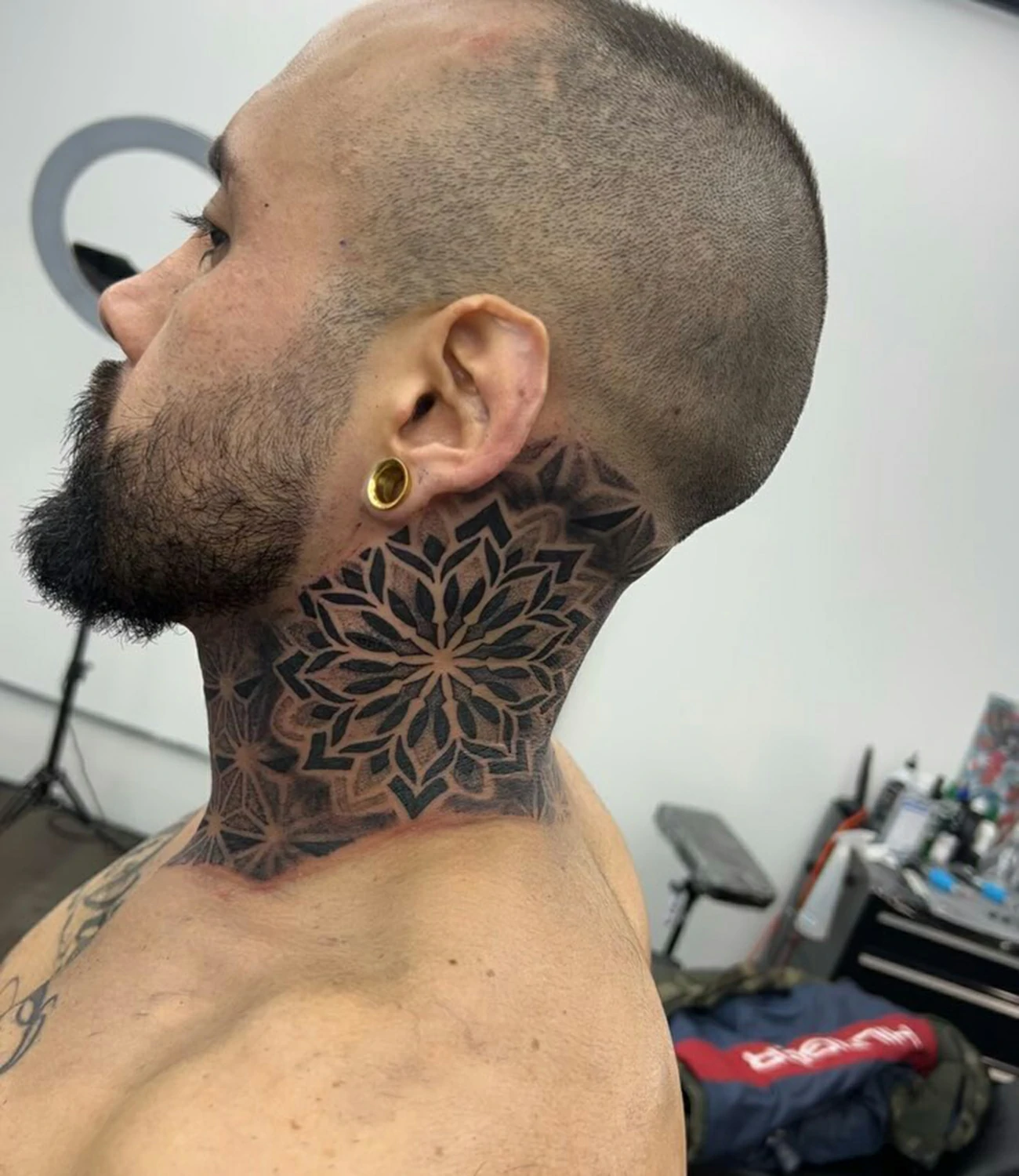 Geometric Neck Tattoo: Geometric neck tattoos feature symmetrical shapes and patterns that enhance the natural lines of the neck, symbolizing individuality and courage.
