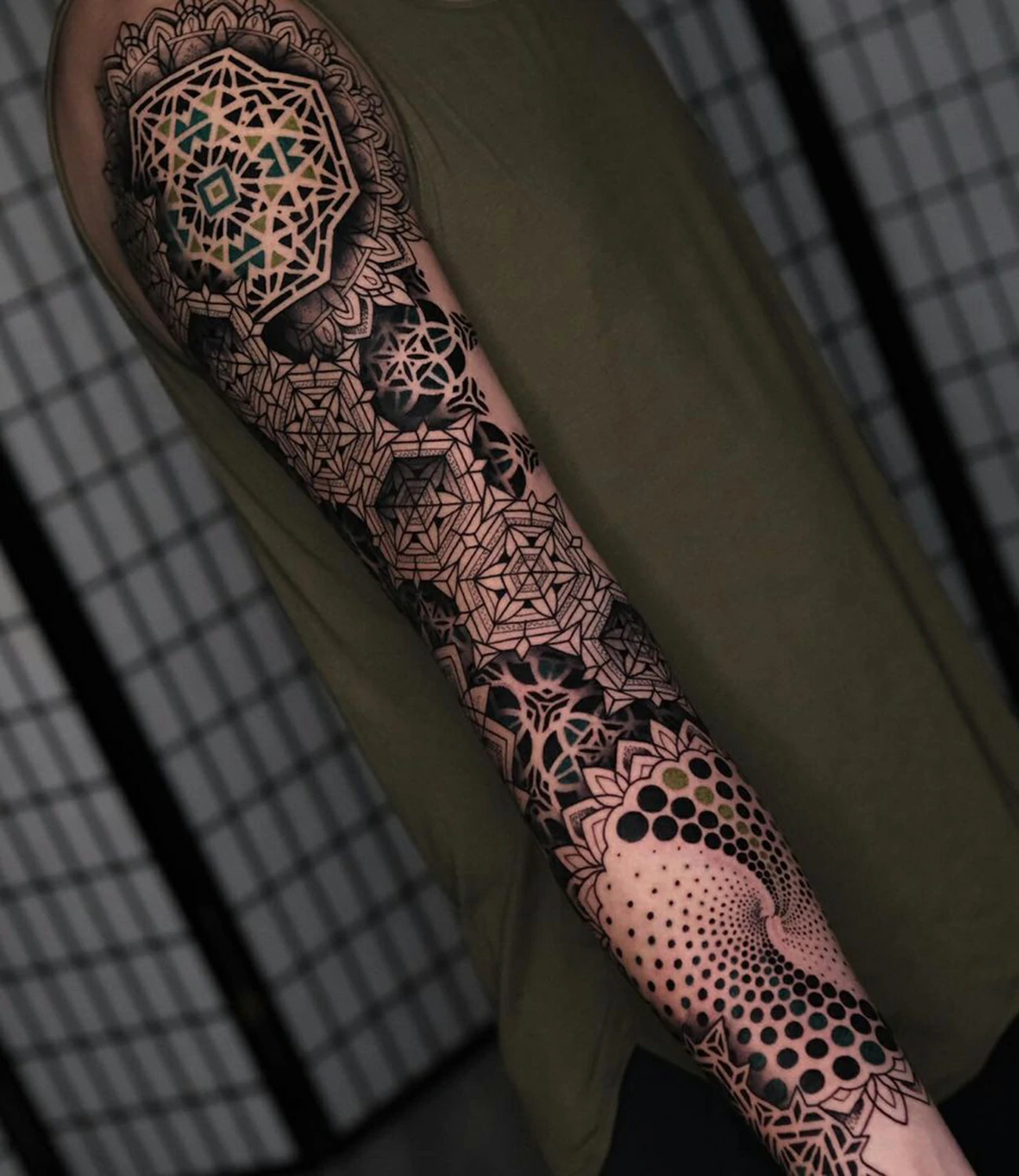 Geometric Sleeve Tattoo: A geometric sleeve tattoo incorporates various shapes and patterns to create a unified and intricate design covering the entire arm.